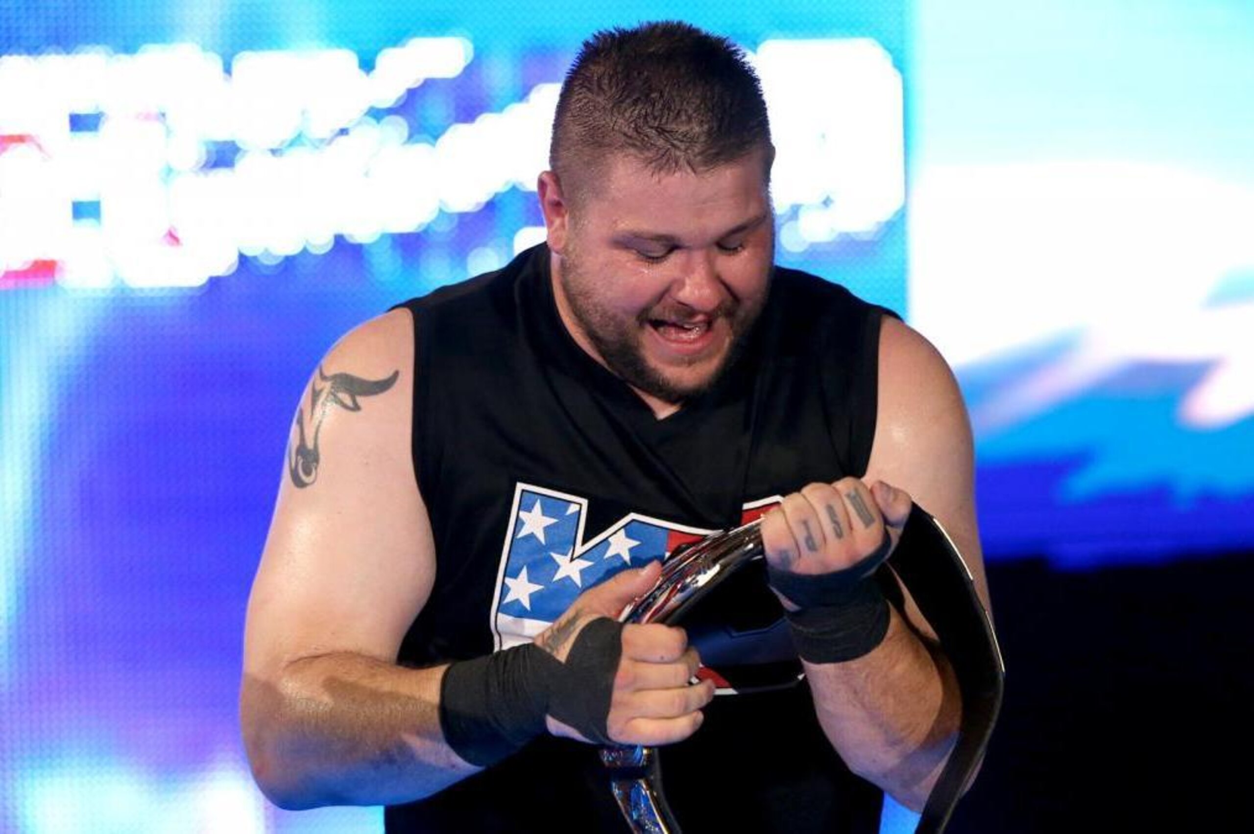 Kevin Owens celebrates reclaiming the United States Championship.