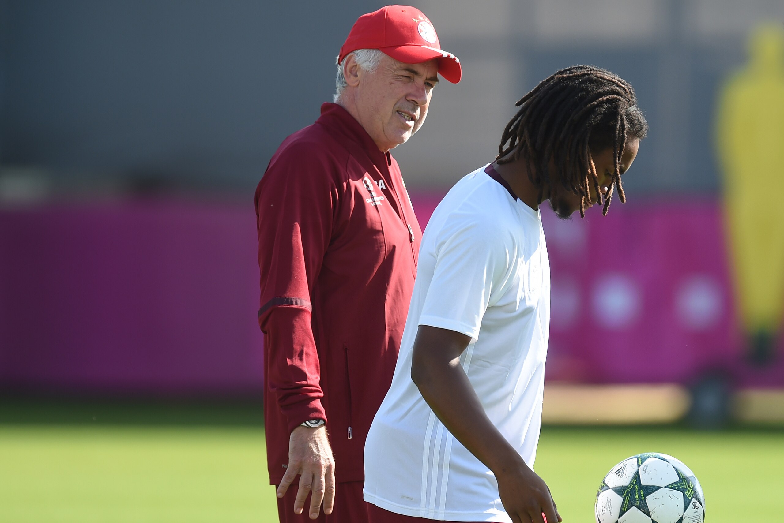 Bayern Munich's Portuguese midfielder Renato Sanches (R) plays the ball beside of Bayern Munich's Italian headcoach Carlo Ancelotti (L) during the final team training session on the eve of the first Champions League group D football match between Bayern M Bayern Munich's Portuguese midfielder Renato Sanches (R) plays the ball beside of Bayern Munich's Italian headcoach Carlo Ancelotti (L) during the final team training session on the eve of the first Champions League group D football match between Bayern M