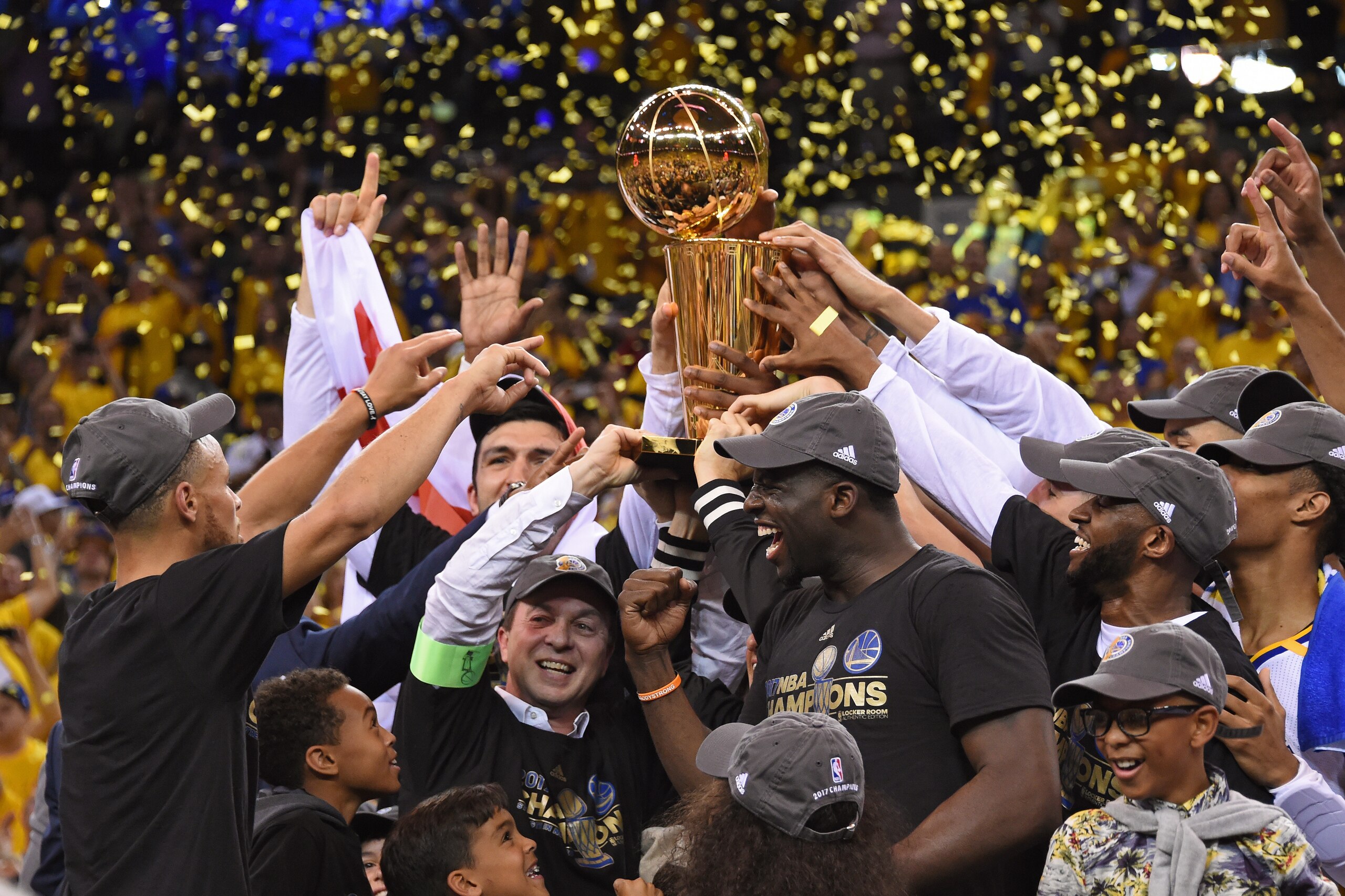 OAKLAND, CA - JUNE 12: Stephen Curry #30, Joe Lacob and Draymond Green #23 of the Golden State Warriors celebrate with the Larry O'Brien Trophy on stage after winning Game Five of the 2017 NBA Finals against the Cleveland Cavaliers on June 12, 2017 at Or OAKLAND, CA - JUNE 12: Stephen Curry #30, Joe Lacob and Draymond Green #23 of the Golden State Warriors celebrate with the Larry O'Brien Trophy on stage after winning Game Five of the 2017 NBA Finals against the Cleveland Cavaliers on June 12, 2017 at Or