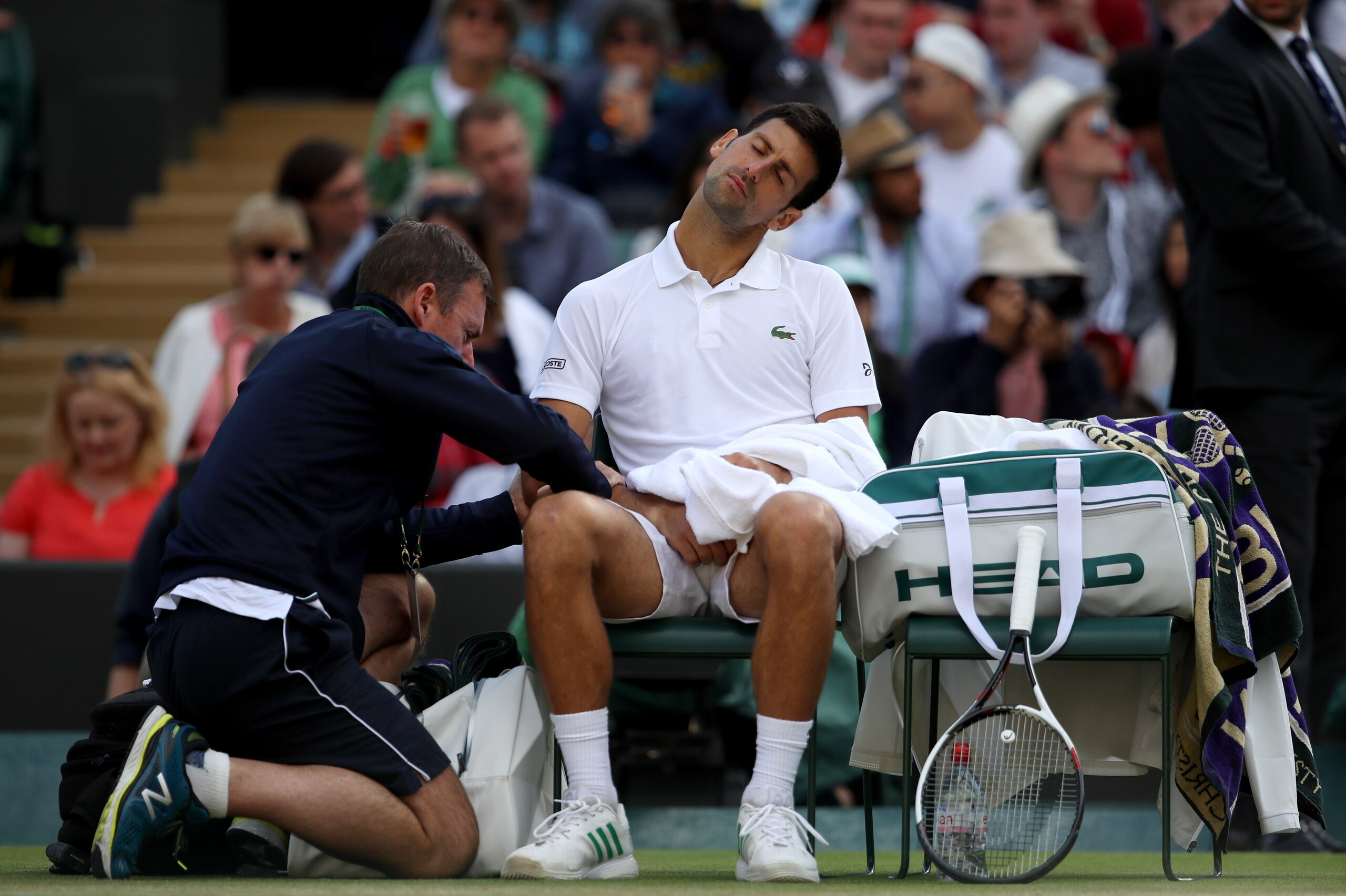 LONDON, ENGLAND - JULY 12:  Novak Djokovic of Serbia is given treatment during the Gentlemen's Singles quarter final match against Tomas Berdych of The Czech Republic on day nine of the Wimbledon Lawn Tennis Championships at the All England Lawn Tennis an