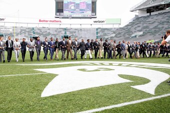 Sep 24, 2016; East Lansing, MI, USA; Michigan State Spartans walk the field near the midfield logo honoring former Michigan State Spartans punter Mike Sadler prior to a game against Wisconsin at Spartan Stadium. Mandatory Credit: Mike Carter-USA TODAY Spo