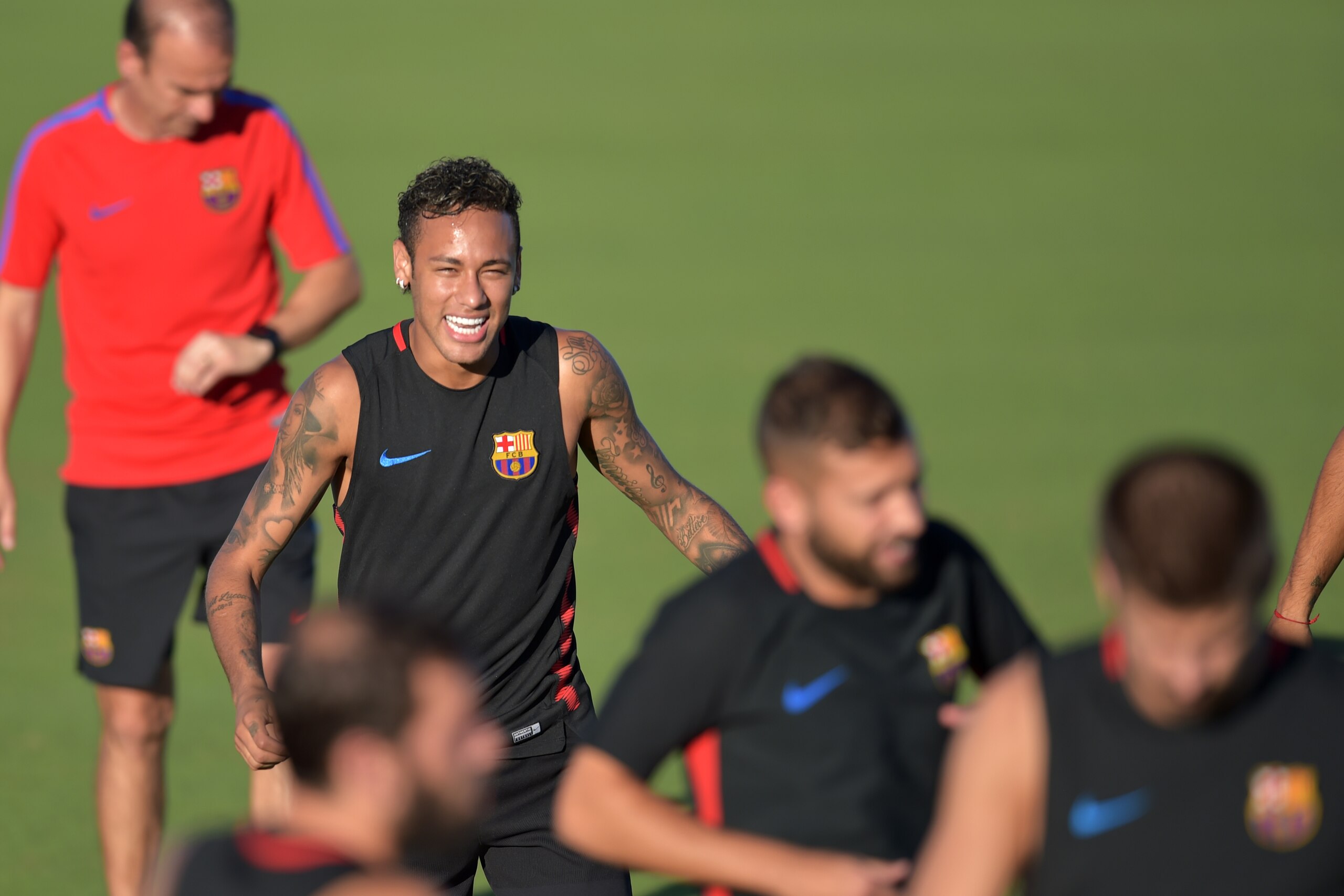 Barcelona player Neymar jokes with teamates during a training session at Barry University in Miami, Florida, on July 27, 2017, two days before their International Champions Cup friendly match against Real Madrid / AFP PHOTO / HECTOR RETAMAL        (Photo 