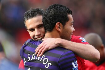 MANCHESTER, ENGLAND - NOVEMBER 03:  Robin van Persie of Manchester United embraces Andre Santos of Arsenal prior to the Barclays Premier League match between Manchester United and Arsenal at Old Trafford on November 3, 2012 in Manchester, England.  (Photo