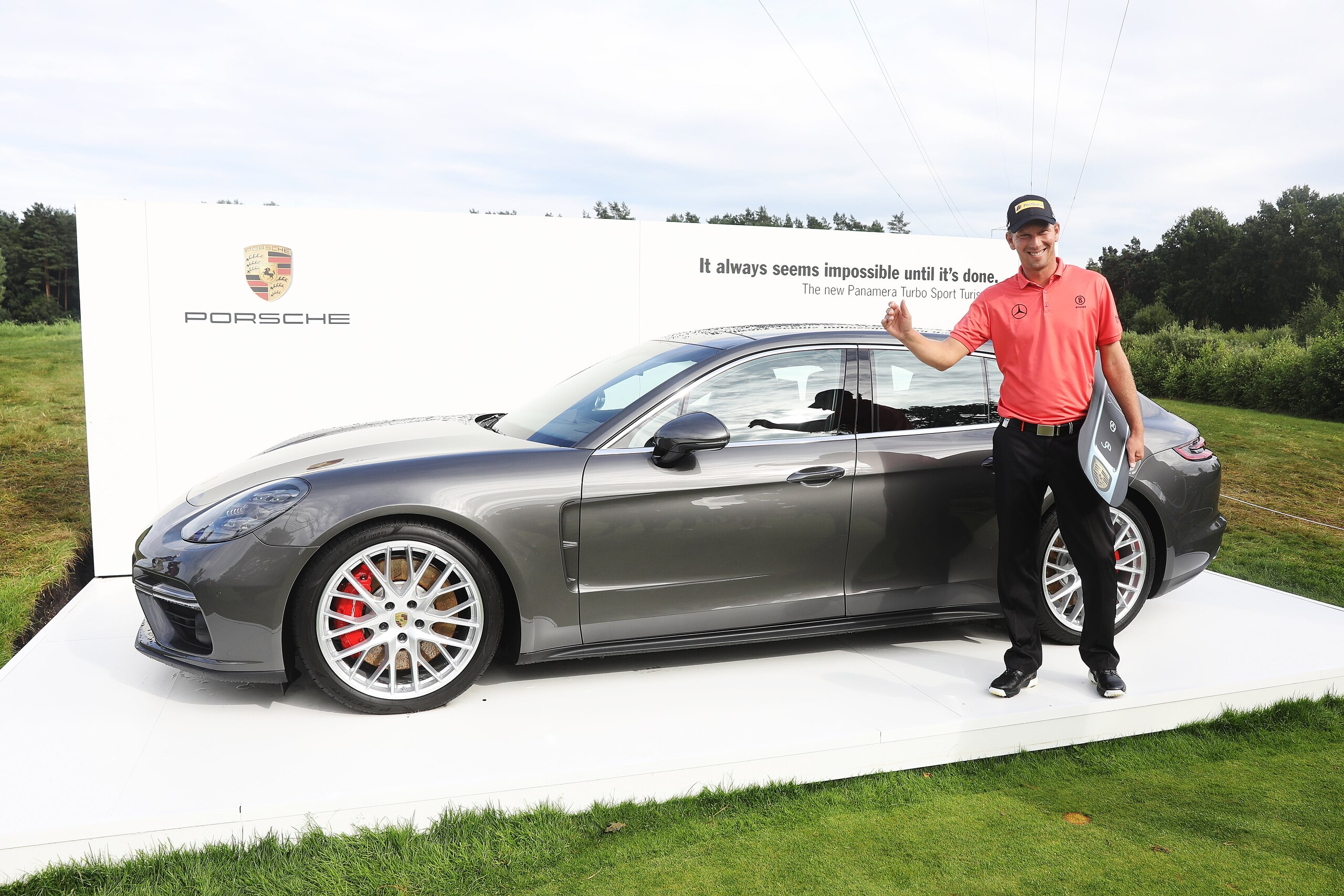 HAMBURG, GERMANY - JULY 29:  Marcel Siem of Germany receive his price Porsche Panamera Sport Turismo after making a hole in one on the 17th hole during the Green Eagle Golf Course on July 29, 2017 in Hamburg, Germany.  (Photo by Oliver Hardt/Getty Images 