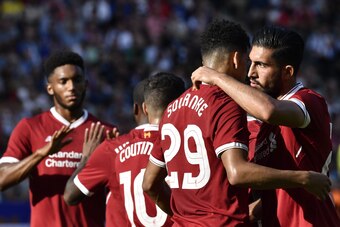 Liverpool's Team players celebrate with Liverpool's English striker Dominic Solanke after he scored 0:1 during a friendly football match Hertha Berlin vs Liverpool in Berlin, Germany, on July 29, 2017.  / AFP PHOTO / John MACDOUGALL        (Photo credit s