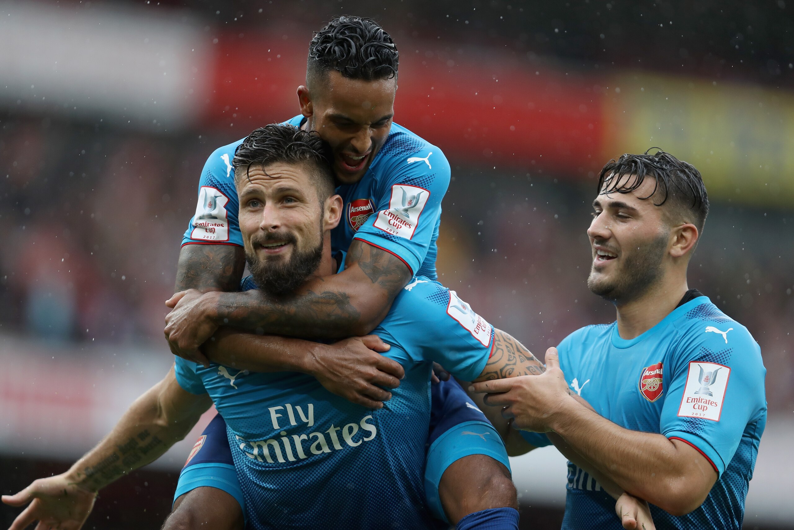 LONDON, ENGLAND - JULY 29: Olivier Giroud of Arsenal celebrates with teammates Theo Walcott and Sead Kolainac after scoring 4-2 during the pre-season friendly match between Arsenal v SL Benfica during the Emirates Cup at Emirates Stadium on July 29, 2017 
