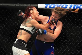 ANAHEIM, CA - JULY 29:  Cris Cyborg of Brazil (L) fights Tonya Evinger during their Featherweight Title fight  at UFC 214 at Honda Center on July 29, 2017 in Anaheim, California.  (Photo by Sean M. Haffey/Getty Images)