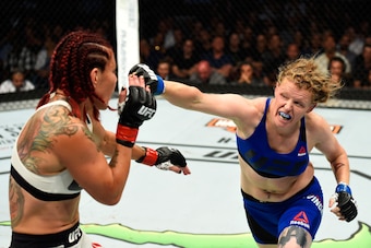 ANAHEIM, CA - JULY 29:  Tonya Evinger punches Cris Cyborg of Brazil in their UFC women's featherweight championship bout during the UFC 214 event at Honda Center on July 29, 2017 in Anaheim, California.  (Photo by Josh Hedges/Zuffa LLC/Zuffa LLC via Getty