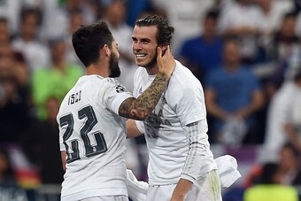 Real Madrid's Welsh forward Gareth Bale (R) celebrates with Real Madrid's midfielder Isco at the end of the UEFA Champions League semi-final second leg football match Real Madrid CF vs Manchester City FC at the Santiago Bernabeu stadium in Madrid, on May 