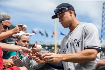 SEATTLE, WA - JULY 23: Aaron Judge #99 of the New York Yankees signs autographs for fans before a game against the Seattle Mariners at Safeco Field on July 23, 2017 in Seattle, Washington. The Yankees won 6-4. (Photo by Stephen Brashear/Getty Images)