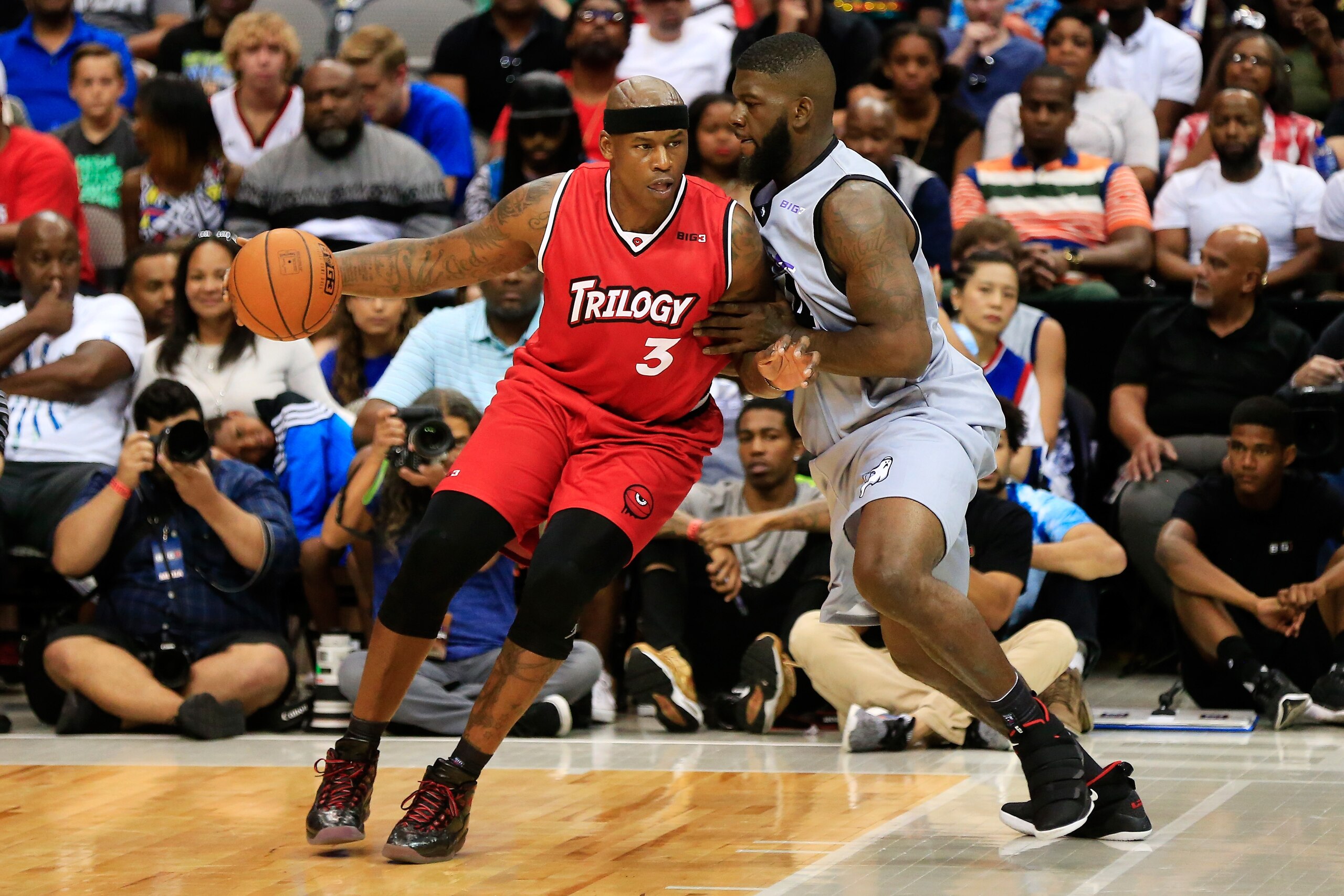 DALLAS, TX - JULY 30:   Al Harrington #3 of Trilogy dribbles the ball while being guarded by Ivan Johnson #44 of the Ghost Ballers during week six of the BIG3 three on three basketball league at American Airlines Center on July 30, 2017 in Dallas, Texas. 