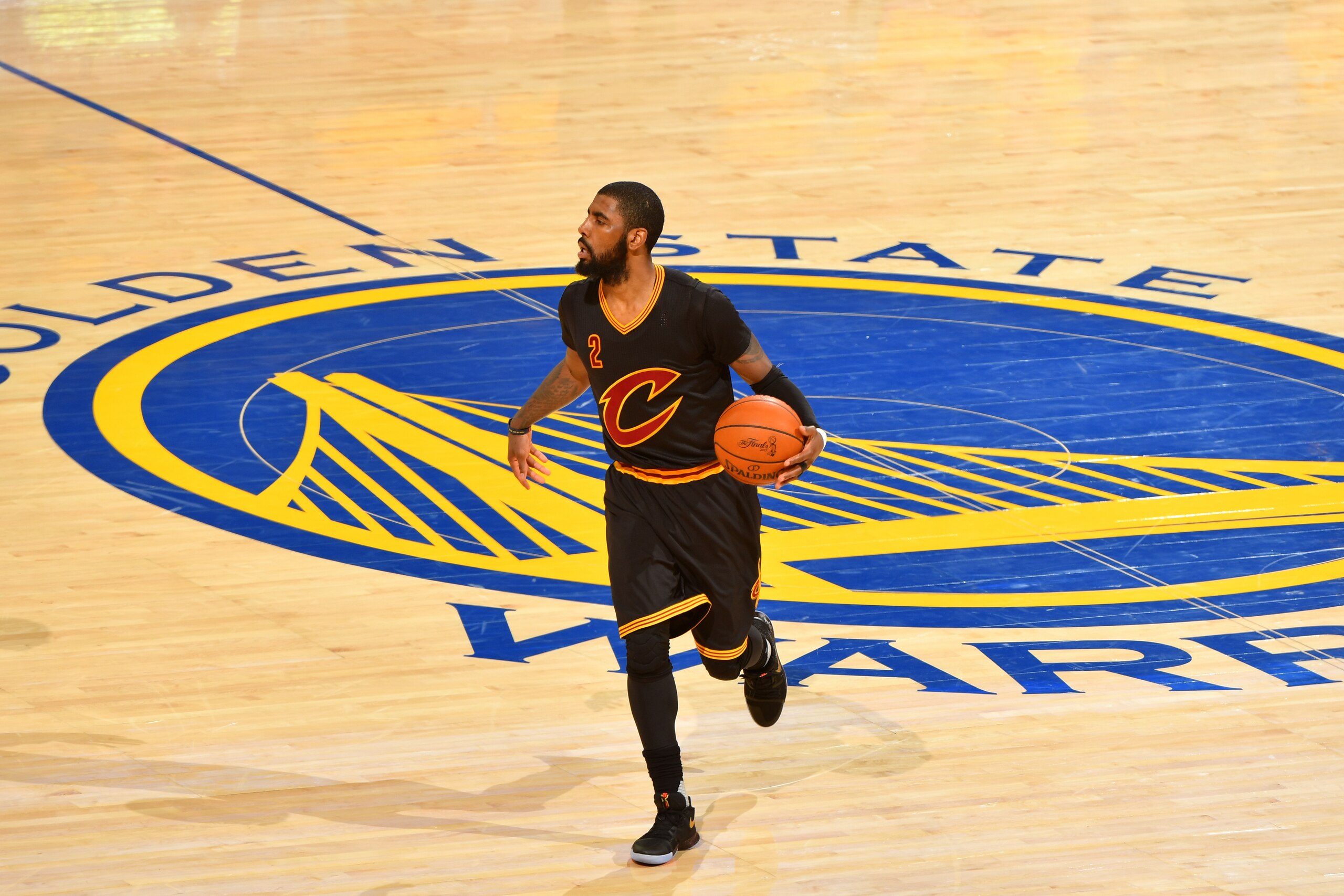 OAKLAND, CA - JUNE 12:  Kyrie Irving #2 of the Cleveland Cavaliers dribbles the ball up court against the Golden State Warriors in Game Five of the 2017 NBA Finals on June 12, 2017 at Oracle Arena in Oakland, California. NOTE TO USER: User expressly ackno