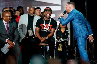 TORONTO, CANADA - JULY 12:  (L-R) Floyd Mayweather Jr. reacts as Conor McGregor takes speaks during the Floyd Mayweather Jr. v Conor McGregor World Press Tour event at Budweiser Stage on July 12, 2017 in Toronto, Ontario, Canada. (Photo by Jeff Bottari/Zu