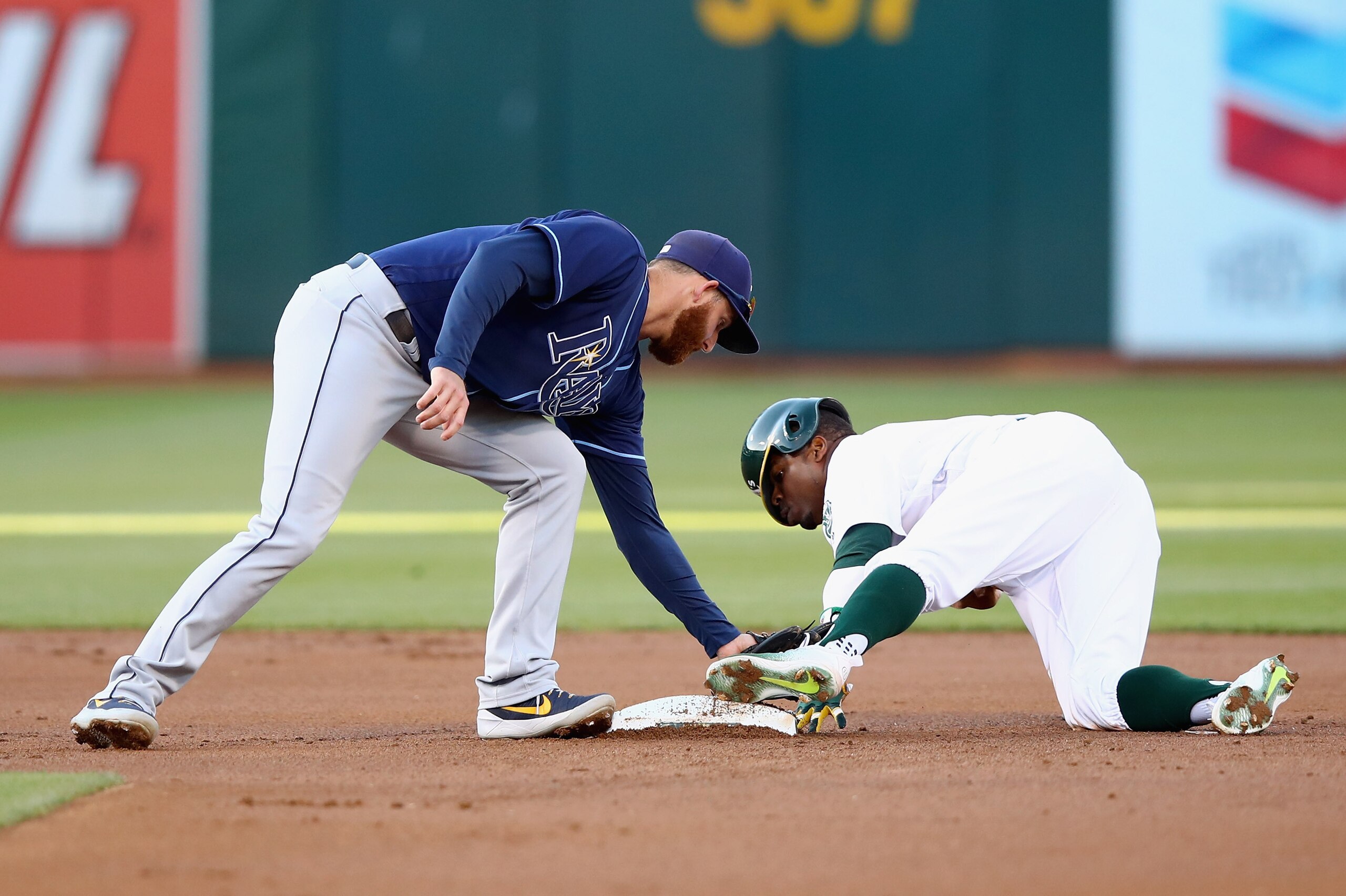 OAKLAND, CA - JULY 18: Rajai Davis #11 of the Oakland Athletics safely beats the tag of Brad Miller #13 of the Tampa Bay Rays to steal second base in the firt inning at Oakland Alameda Coliseum on July 18, 2017 in Oakland, California. (Photo by Ezra Sha OAKLAND, CA - JULY 18: Rajai Davis #11 of the Oakland Athletics safely beats the tag of Brad Miller #13 of the Tampa Bay Rays to steal second base in the firt inning at Oakland Alameda Coliseum on July 18, 2017 in Oakland, California. (Photo by Ezra Sha