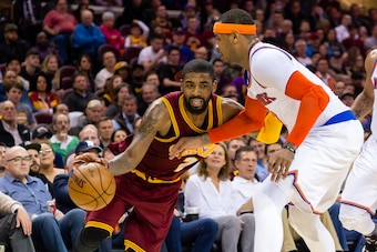 CLEVELAND, OH - FEBRUARY 23: Kyrie Irving #2 of the Cleveland Cavaliers drives around Carmelo Anthony #7 of the New York Knicks during the second half at Quicken Loans Arena on February 23, 2017 in Cleveland, Ohio. The Cavaliers defeated the Knicks 119-10