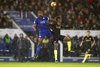 Leicester City's English-born Jamaican defender Wes Morgan (L) vies with Manchester City's Nigerian striker Kelechi Iheanacho during the English Premier League football match between Leicester City and Manchester City at King Power Stadium in Leicester, c