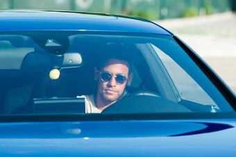 Barcelona's Brazilian forward Neymar drives into the parkinglot to takes part in a training session at the Sports Center FC Barcelona Joan Gamper in Sant Joan Despi, near Barcelona on August 2, 2017 following rumour that Neymar is considering a move to Fr