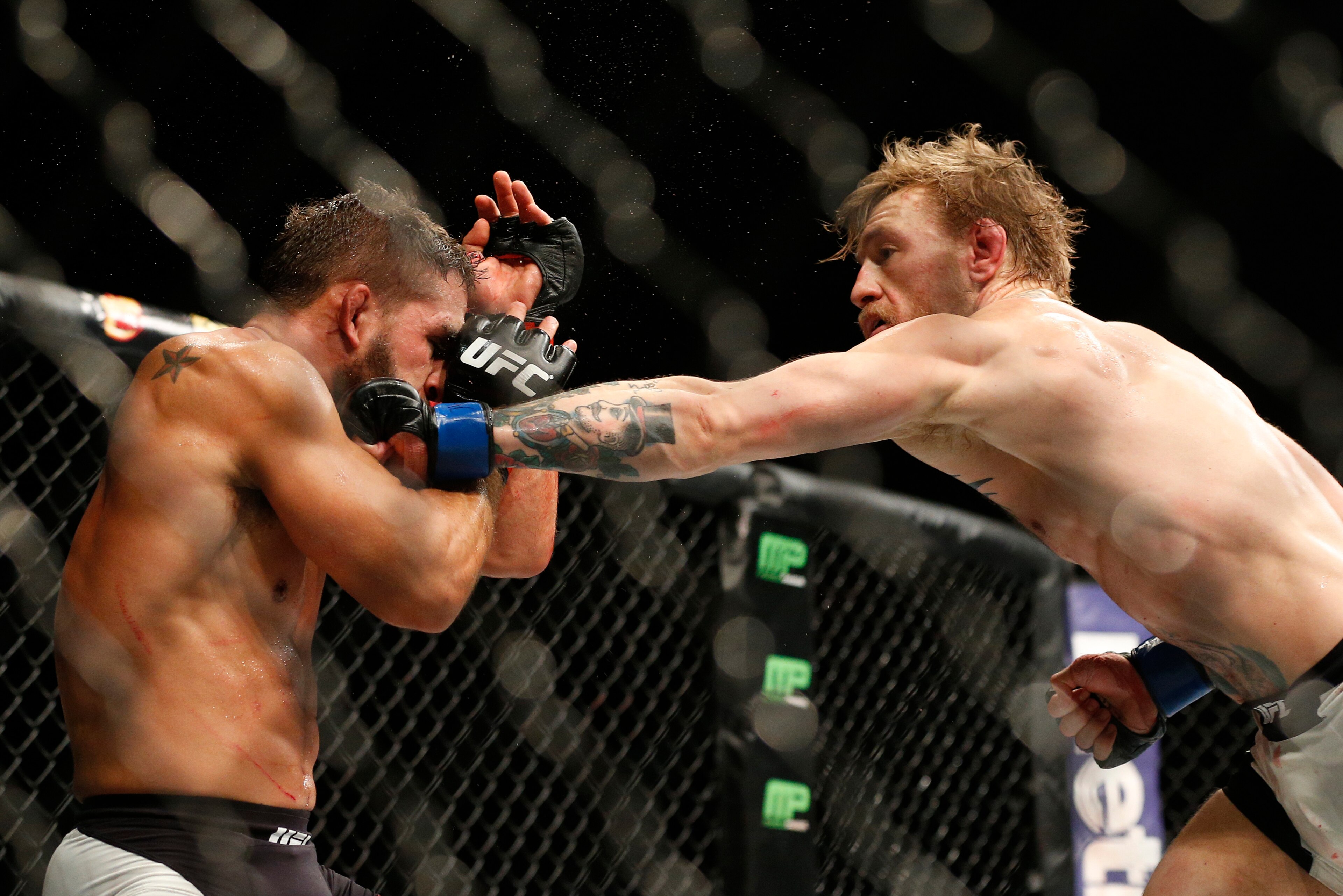 McGregor lands a left hand around the guard of Chad Mendes at UFC 189 on July 11, 2015. McGregor lands a left hand around the guard of Chad Mendes at UFC 189 on July 11, 2015.