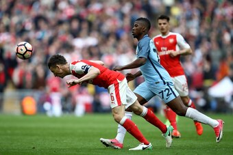 LONDON, ENGLAND - APRIL 23: Laurent Koscielny of Arsenal heads the ball in front of Kelechi Iheanacho of Manchester City during the Emirates FA Cup Semi-Final match between Arsenal and Manchester City at Wembley Stadium on April 23, 2017 in London, Englan