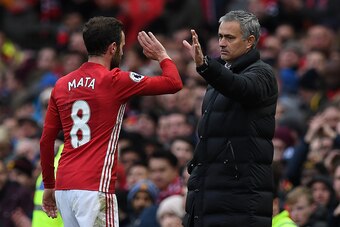Manchester United's Portuguese manager Jose Mourinho (R) congratulates Manchester United's Spanish midfielder Juan Mata as he is substituted off during the English Premier League football match between Manchester United and Arsenal at Old Trafford in Manc