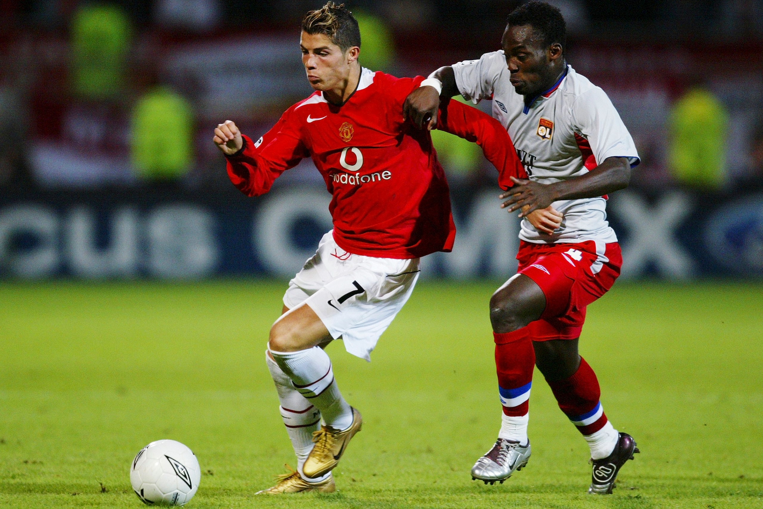 LYON, FRANCE - SEPTEMBER 15:  Cristiano Ronaldo of Manchester United tangles with Mickael Essien of Lyon during the UEFA Champions League Group D match between Olympique Lyonnais and Manchester United at the Municipal de Garland Stadium on September 15, 2