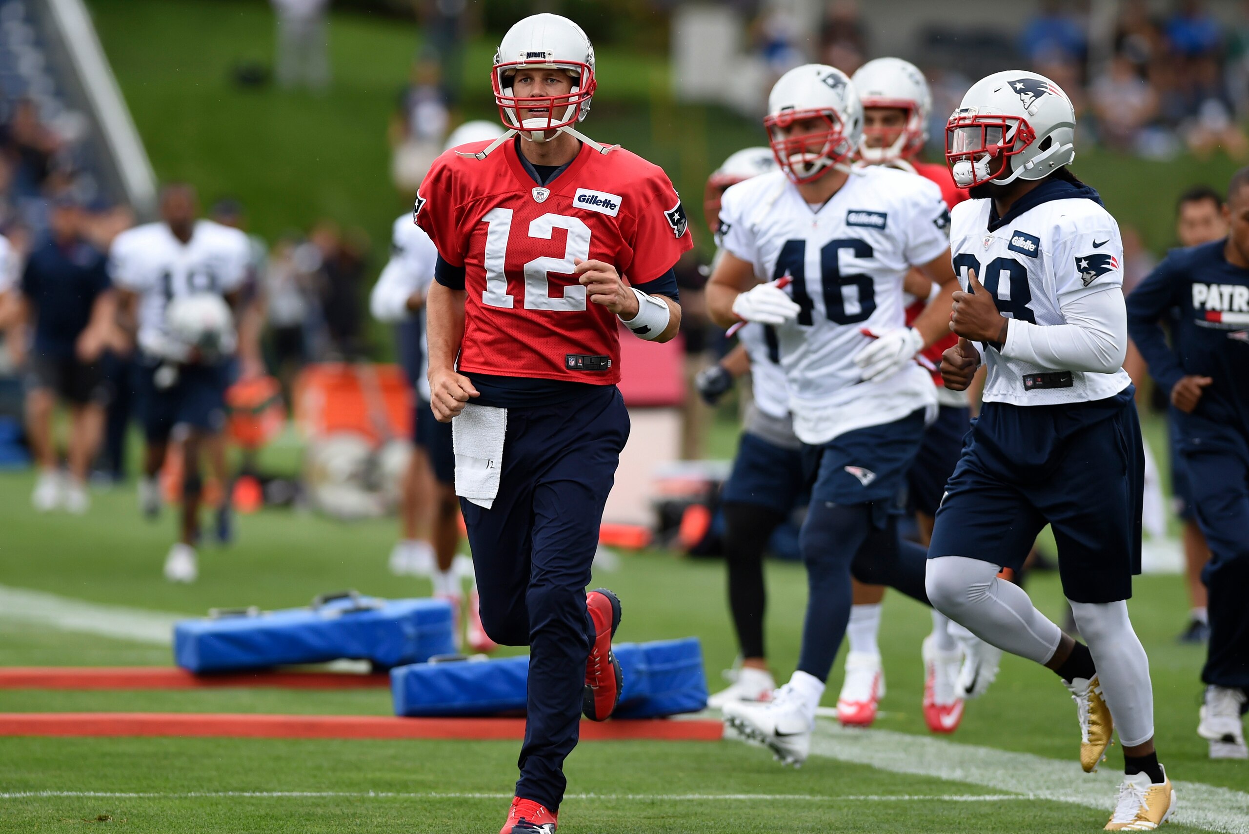 Jul 27, 2017; Foxborough, MA, USA; New England Patriots quarterback Tom Brady (12) runs on to the field during training camp at Gillette Stadium. Mandatory Credit: Bob DeChiara-USA TODAY Sports
