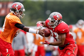 TAMPA, FL - JULY 30: Quarterback Jameis Winston #3 hands off the ball to Runningback Doug Martin #22 of the Tampa Bay Buccaneers works out during Training Camp at One Buc Place on July 30, 2017 in Tampa, Florida. (Photo by Don Juan Moore/Getty Images)