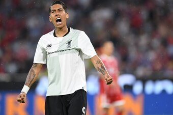 Liverpool's Brazilian striker Roberto Firmino reacts after the first goal for Liverpool during the second Audi Cup football match between FC Bayern Munich and FC Liverpool in the stadium in Munich, southern Germany, on August 1, 2017.  / AFP PHOTO / Chris