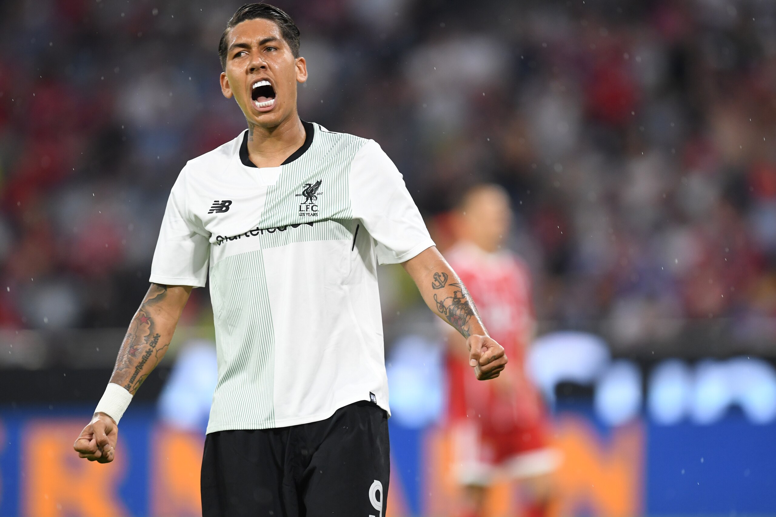 Liverpool's Brazilian striker Roberto Firmino reacts after the first goal for Liverpool during the second Audi Cup football match between FC Bayern Munich and FC Liverpool in the stadium in Munich, southern Germany, on August 1, 2017.  / AFP PHOTO / Chris