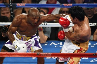 LAS VEGAS, NEVADA - APRIL 09:  Timothy Bradley Jr. (L) throws a left at Manny Pacquiao in the fourth round of their welterweight fight at MGM Grand Garden Arena on April 9, 2016 in Las Vegas, Nevada. Pacquiao won by unanimous decision.  (Photo by Ethan Mi