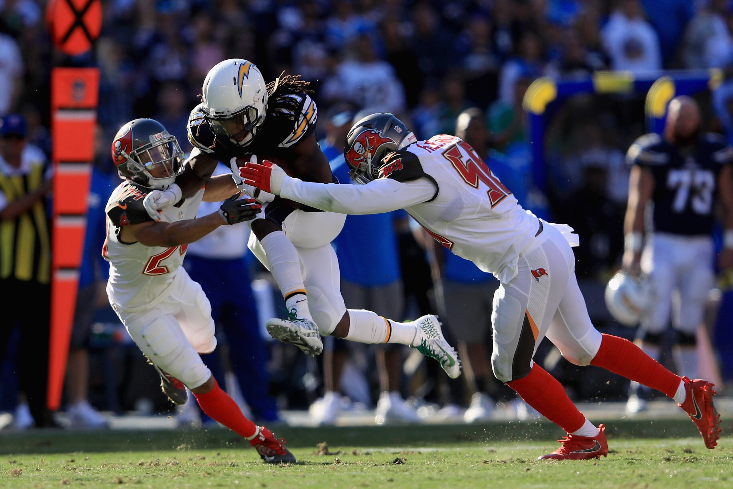 SAN DIEGO, CA - DECEMBER 04: Brent Grimes #24 and Kwon Alexander #58 of the Tampa Bay Buccaneers tackle Melvin Gordon #28 of the San Diego Chargers on a run play during the first half of a game at Qualcomm Stadium on December 4, 2016 in San Diego, Califor