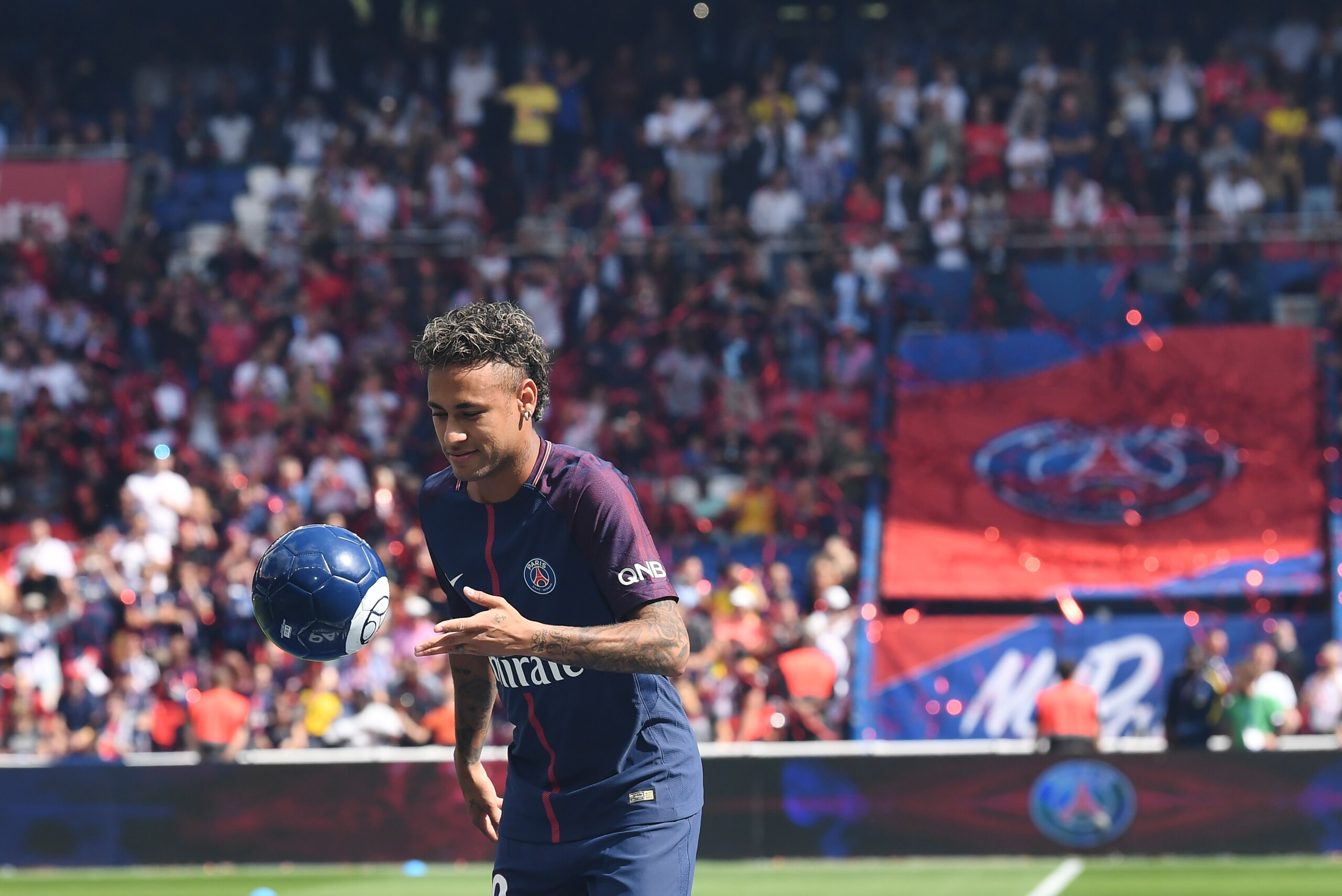 Paris Saint-Germain's Brazilian forward Neymar plays with a ball during his presentation to the fans at the Parc des Princes stadium in Paris on August 5, 2017. 
Brazil superstar Neymar will watch from the stands as Paris Saint-Germain open their season o