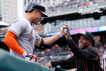 DETROIT, MI - JUNE 28:  Giancarlo Stanton #27 of the Miami Marlins is congratulated by hitting coach Barry Bonds #25 after hitting a two-run home run against the Detroit Tigers during the second inning at Comerica Park on June 28, 2016 in Detroit, Michiga