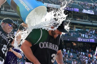 Sep 5, 2016; Denver, CO, USA; Colorado Rockies starting pitcher Chad Bettis (35) is dunked with ice water by catcher Tom Murphy (23) following a win over the San Francisco Giants at Coors Field. Mandatory Credit: Ron Chenoy-USA TODAY Sports