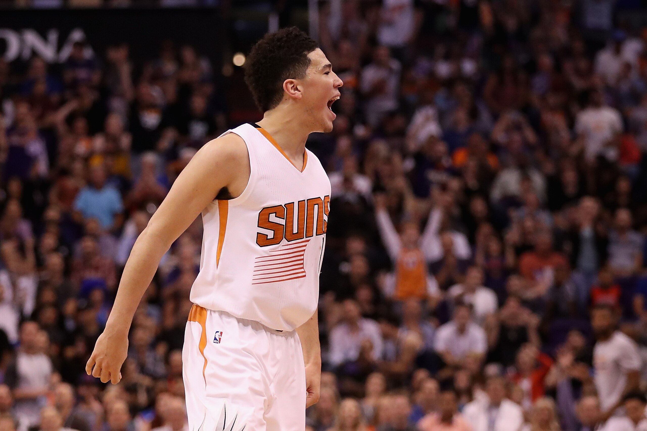 PHOENIX, AZ - APRIL 07:  Devin Booker #1 of the Phoenix Suns reacts to fans after scoring against the Oklahoma City Thunder during the second half of the NBA game at Talking Stick Resort Arena on April 7, 2017 in Phoenix, Arizona.  The Suns defeated the T