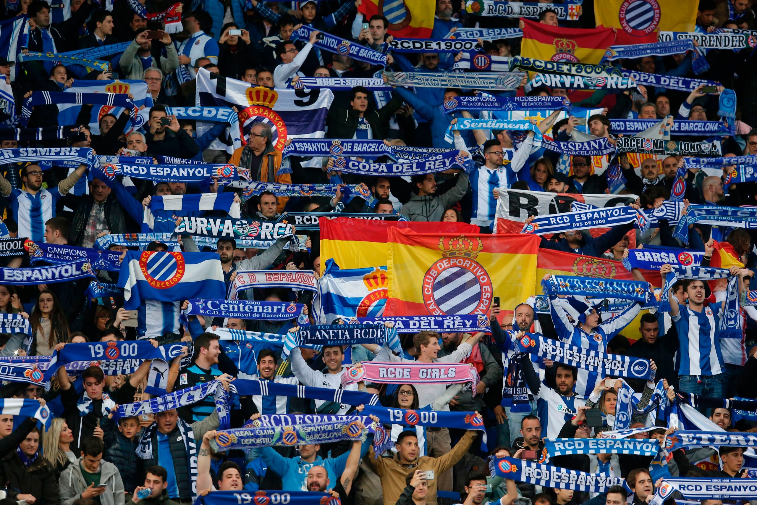 RCD Espanyol supporters wave scarves before the Spanish league football match RCD Espanyol vs FC Barcelona at the Cornella-El Prat stadium in Cornella de Llobregat on April 29, 2017.
Barcelona won 3-0. / AFP PHOTO / PAU BARRENA        (Photo credit should