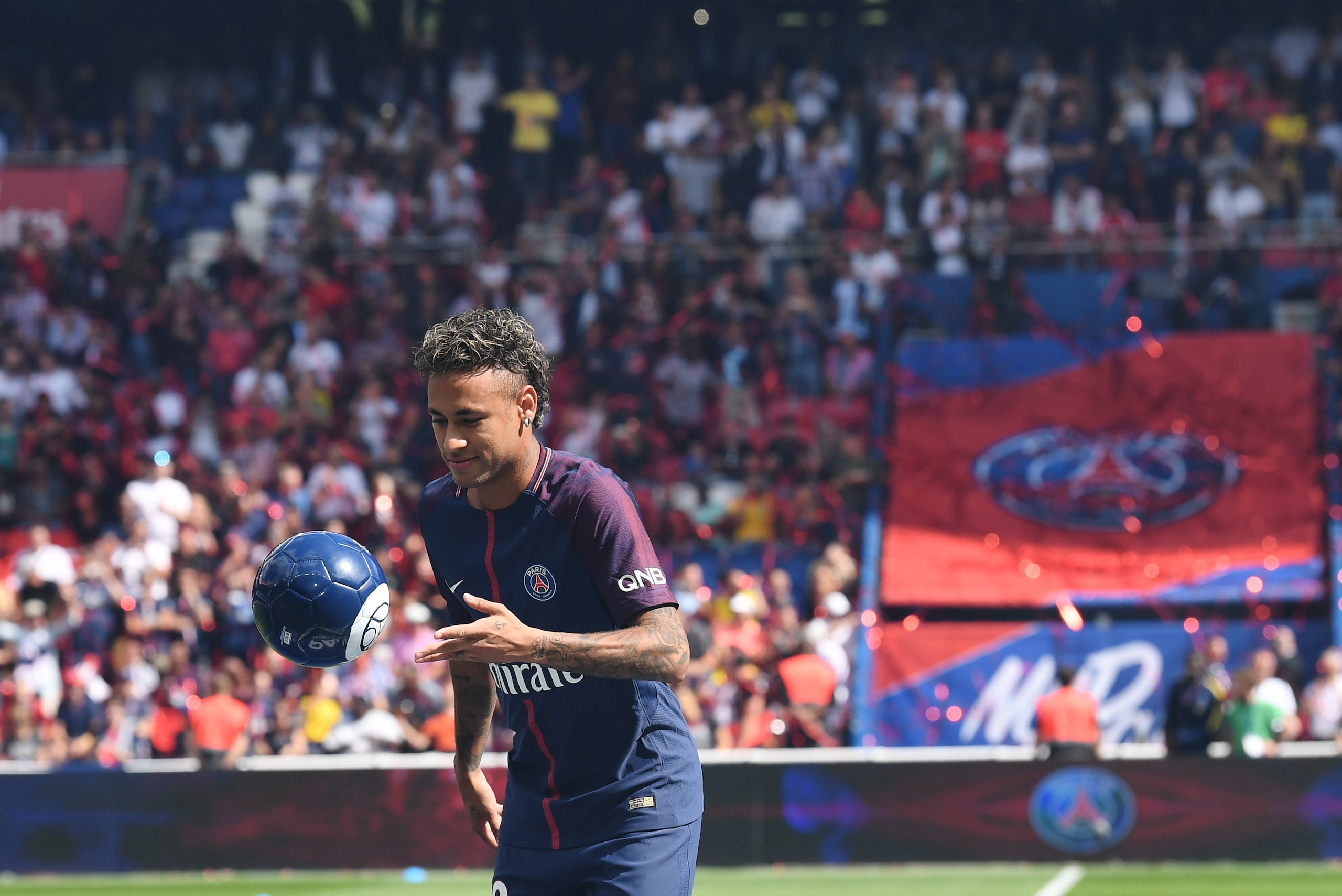 Paris Saint-Germain's Brazilian forward Neymar plays with a ball during his presentation to the fans at the Parc des Princes stadium in Paris on August 5, 2017. 
Brazil superstar Neymar will watch from the stands as Paris Saint-Germain open their season o