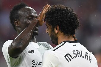 Liverpool's Senegalese striker Sadio Mane (L) and his teammate Liverpool's Egyptian striker Mohamed Salah (R) react after the second goal for Liverpool during the second Audi Cup football match between FC Bayern Munich and FC Liverpool in the stadium in M