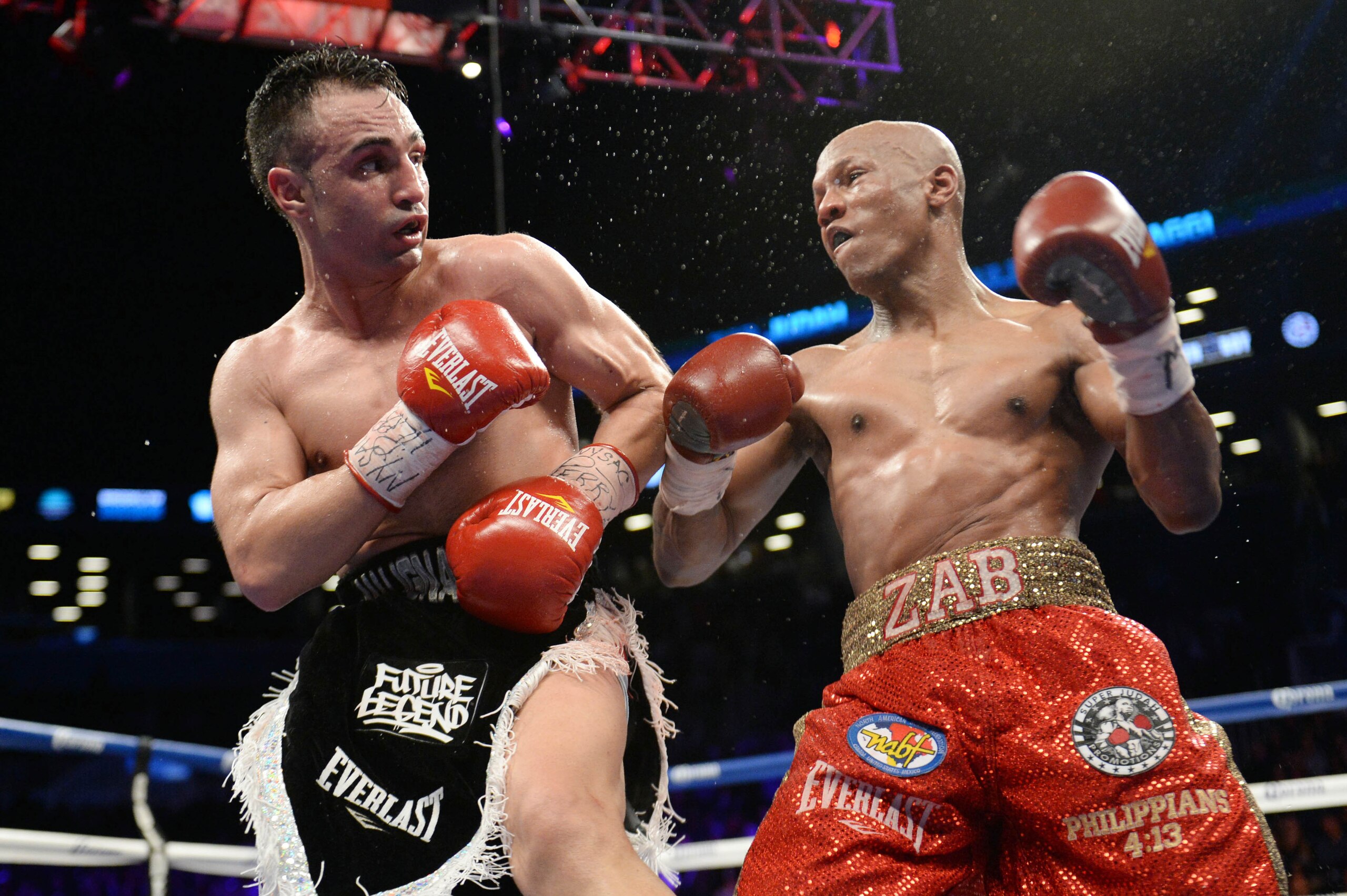 Dec 7, 2013; Brooklyn, NY, USA; Zab Judah (red trunks) and Paulie Malignaggi (black trunks) box during their NABF Welterweight Title bout at Barclays Center. Malignaggi won via unanimous decision.Mandatory Credit: Joe Camporeale-USA TODAY Sports