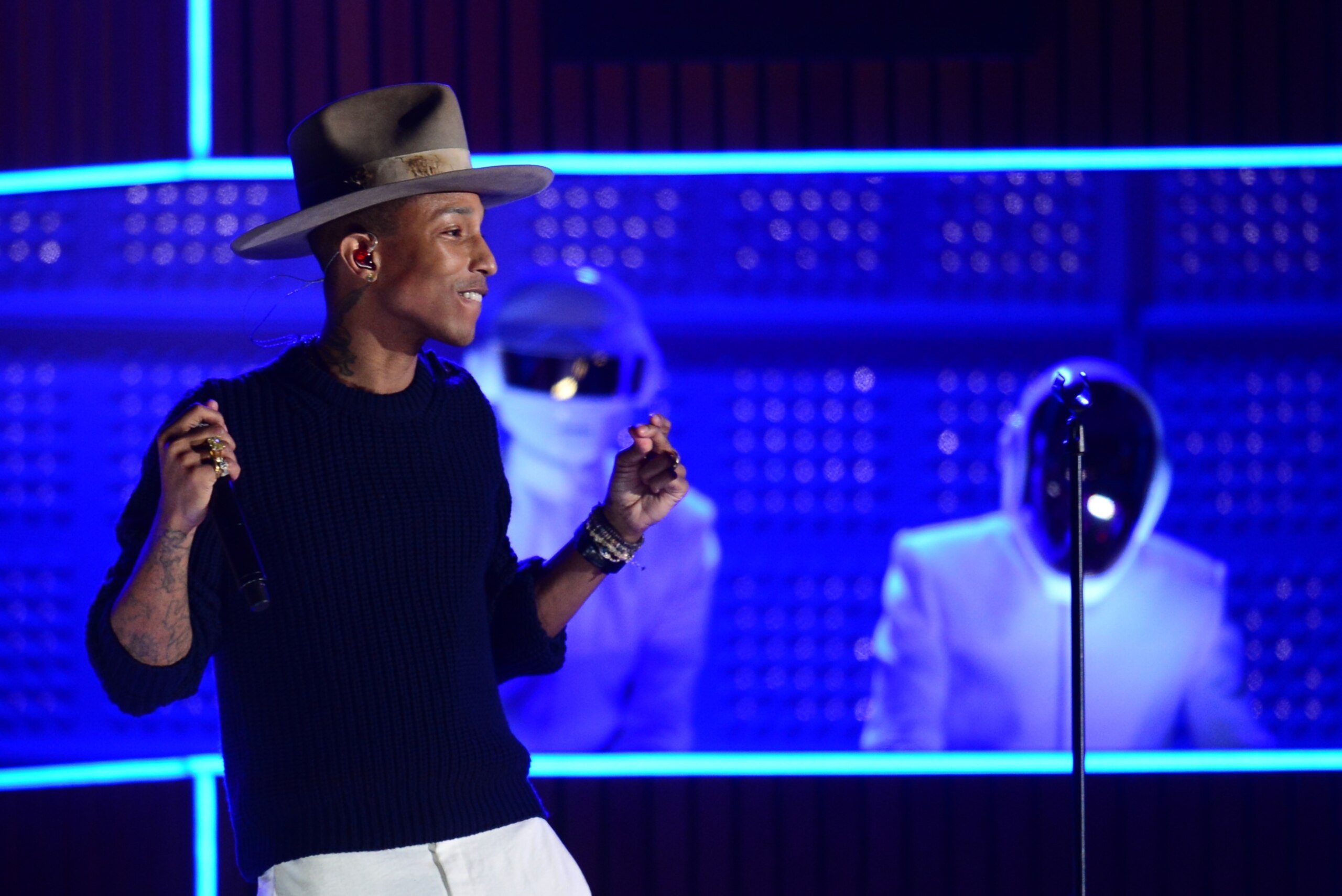 Pharrell Williams and Daft Punk perform on stage at the Staples Center in Los Angeles, California, January 26, 2014. AFP PHOTO FREDERIC J. BROWN        (Photo credit should read FREDERIC J. BROWN/AFP/Getty Images)