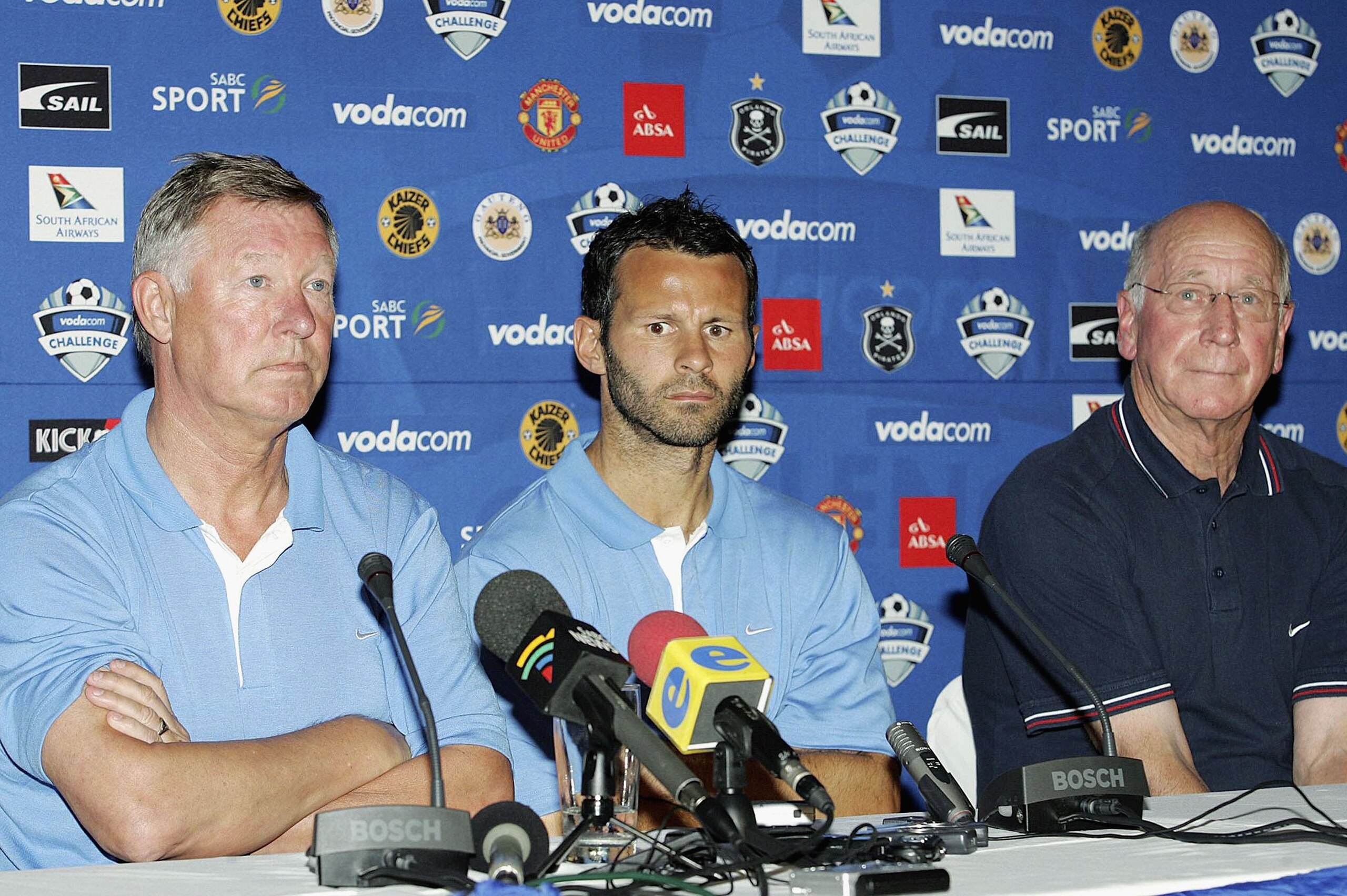 DURBAN, SOUTH AFRICA - 14 JULY 2006. Sir Alex Ferguson, Ryan Giggs and Sir Bobby Charlton talk to the media during the Manchester United global kit launch at ABSA Park on July 14, 2006 in Durban, South Africa. (Photo by Touchline Photo/Getty Images)