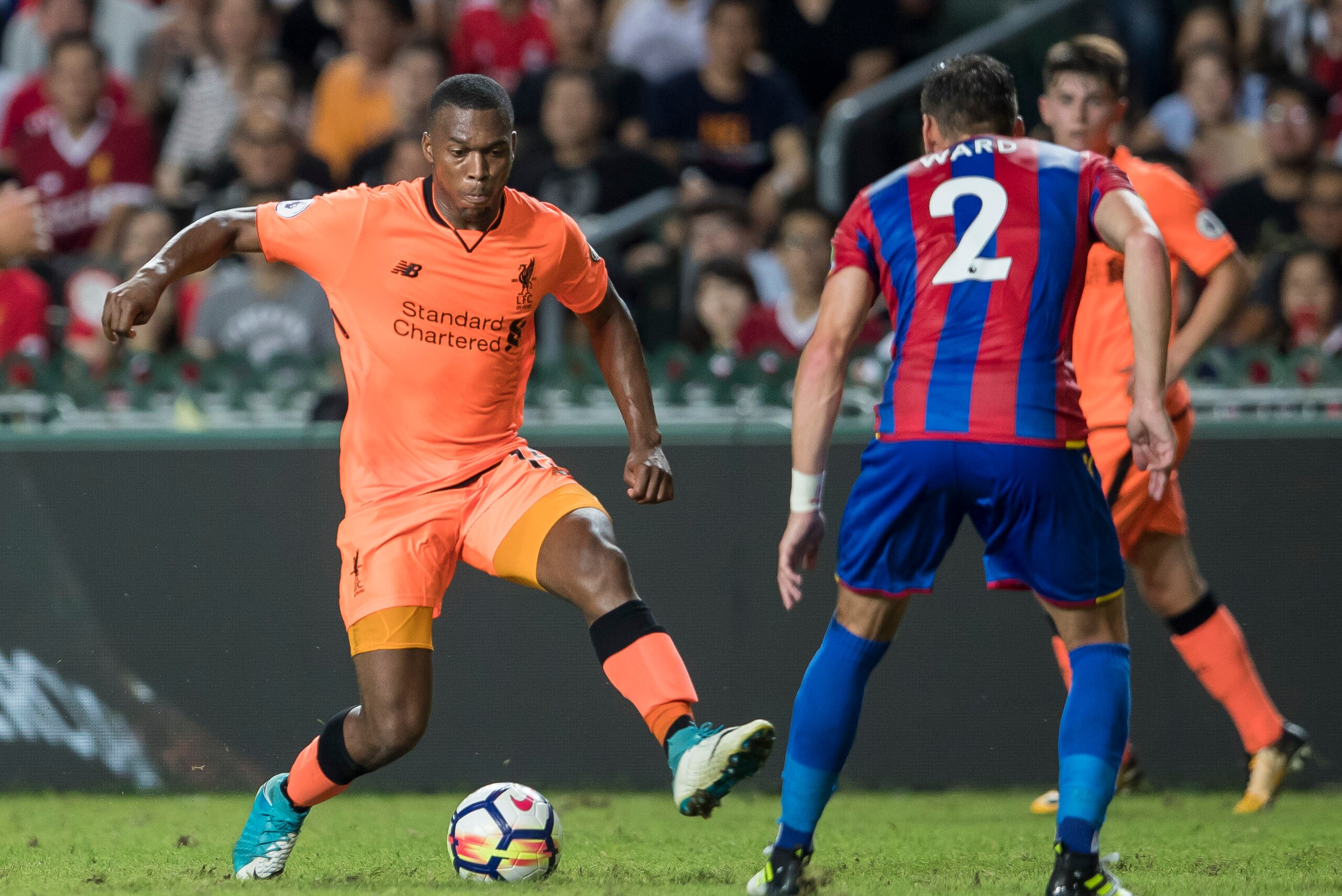 HONG KONG, HONG KONG - JULY 19: Liverpool FC forward Daniel Sturridge (L) fights for the ball with Crystal Palace defender Joel Ward  (R) during the Premier League Asia Trophy match between Liverpool FC and Crystal Palace FC at Hong Kong Stadium on July 1