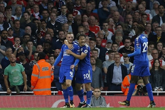 Leicester City's English striker Jamie Vardy (L) celebrates with Leicester City's Japanese striker Shinji Okazaki after scoring their second goal during the English Premier League football match between Arsenal and Leicester City at the Emirates Stadium i