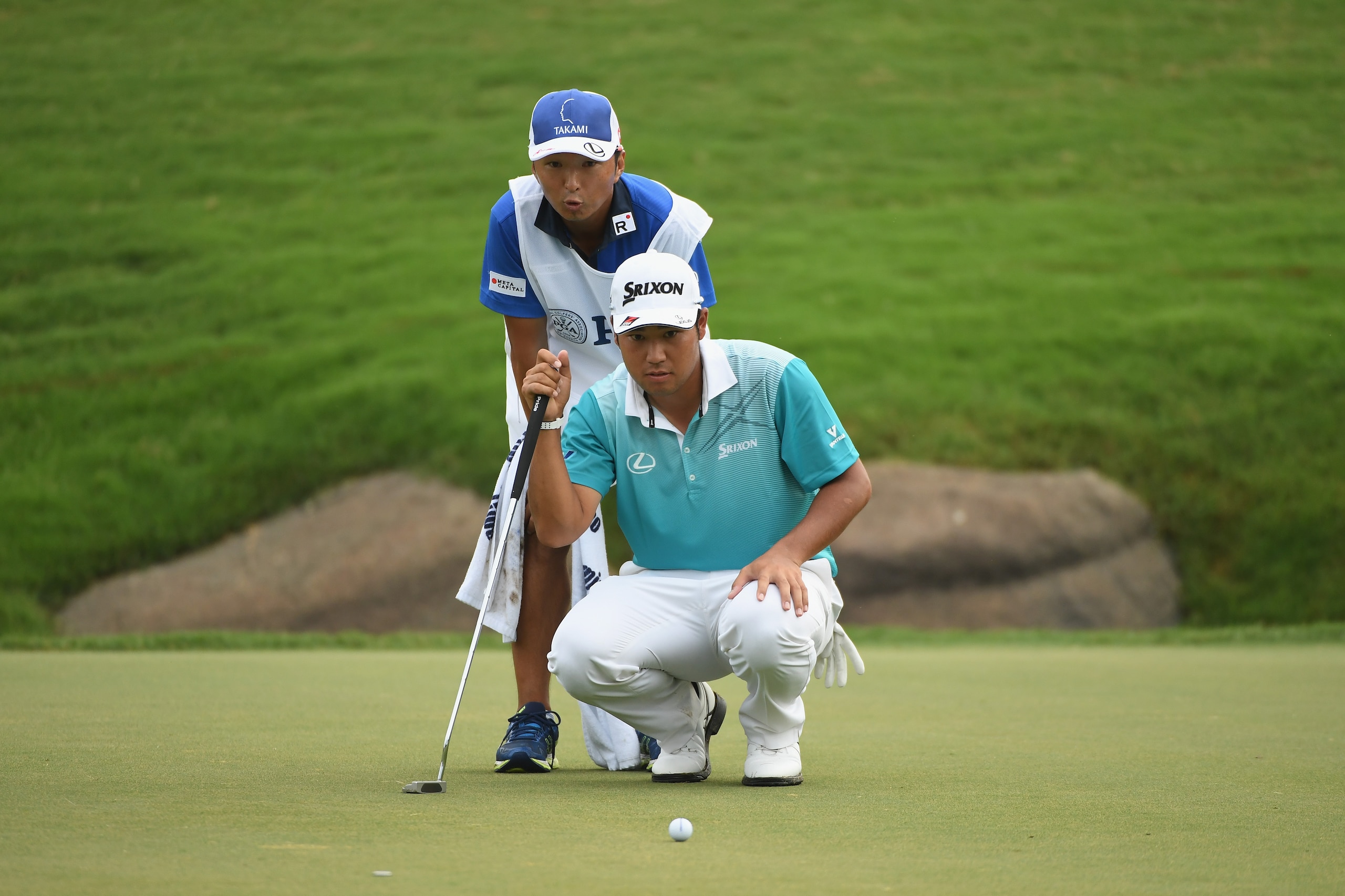 CHARLOTTE, NC - AUGUST 11:  Hideki Matsuyama of Japan and his caddie Daisuke Shindo lines up a putt on the 18th green during the second round of the 2017 PGA Championship at Quail Hollow Club on August 11, 2017 in Charlotte, North Carolina.  (Photo by Ros