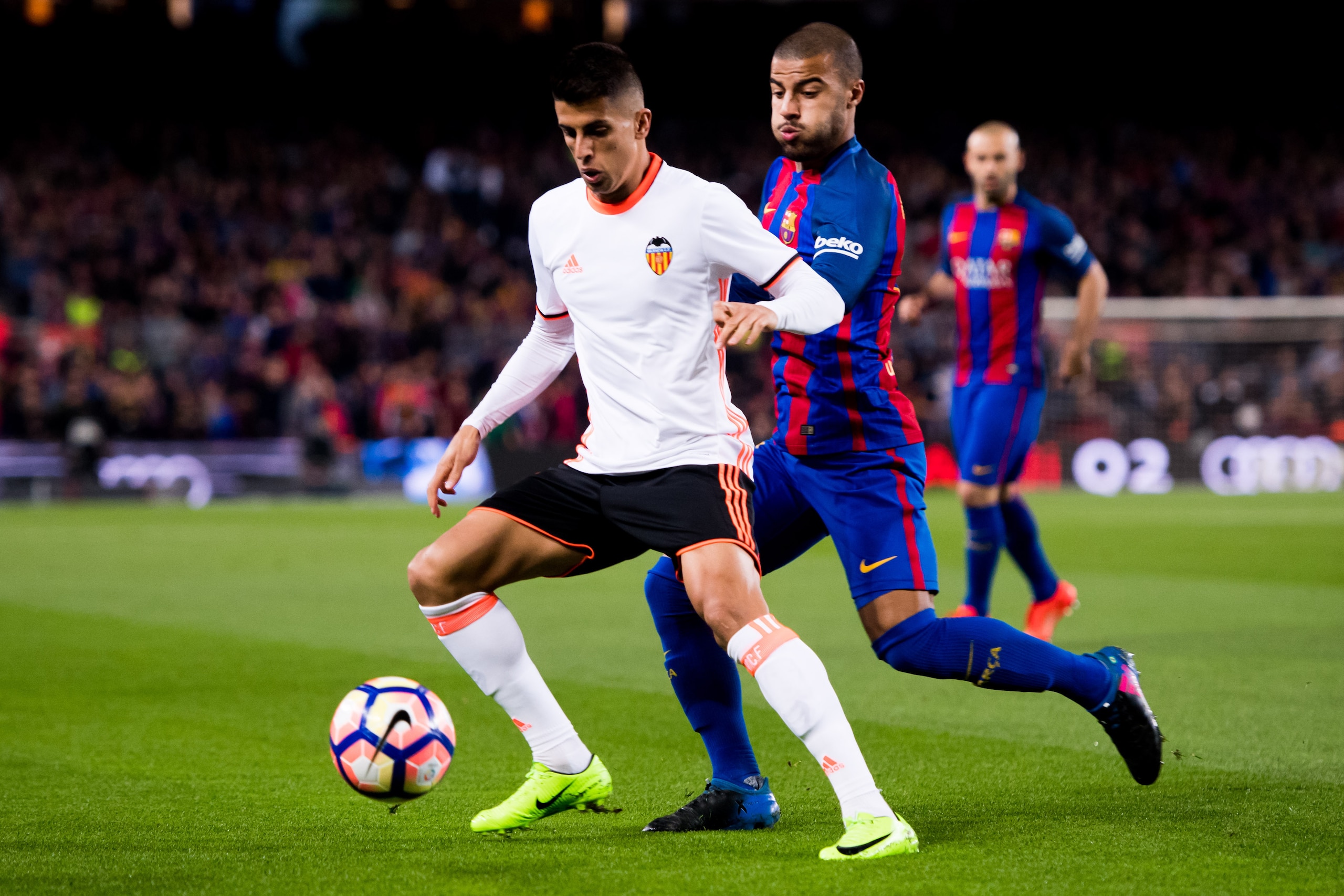 BARCELONA, SPAIN - MARCH 19: Joao Cancelo (L) of Valencia CF protects the ball from Rafinha of FC Barcelona during the La Liga match between FC Barcelona and Valencia CF at Camp Nou stadium on March 19, 2017 in Barcelona, Spain. (Photo by Alex Caparros/Ge