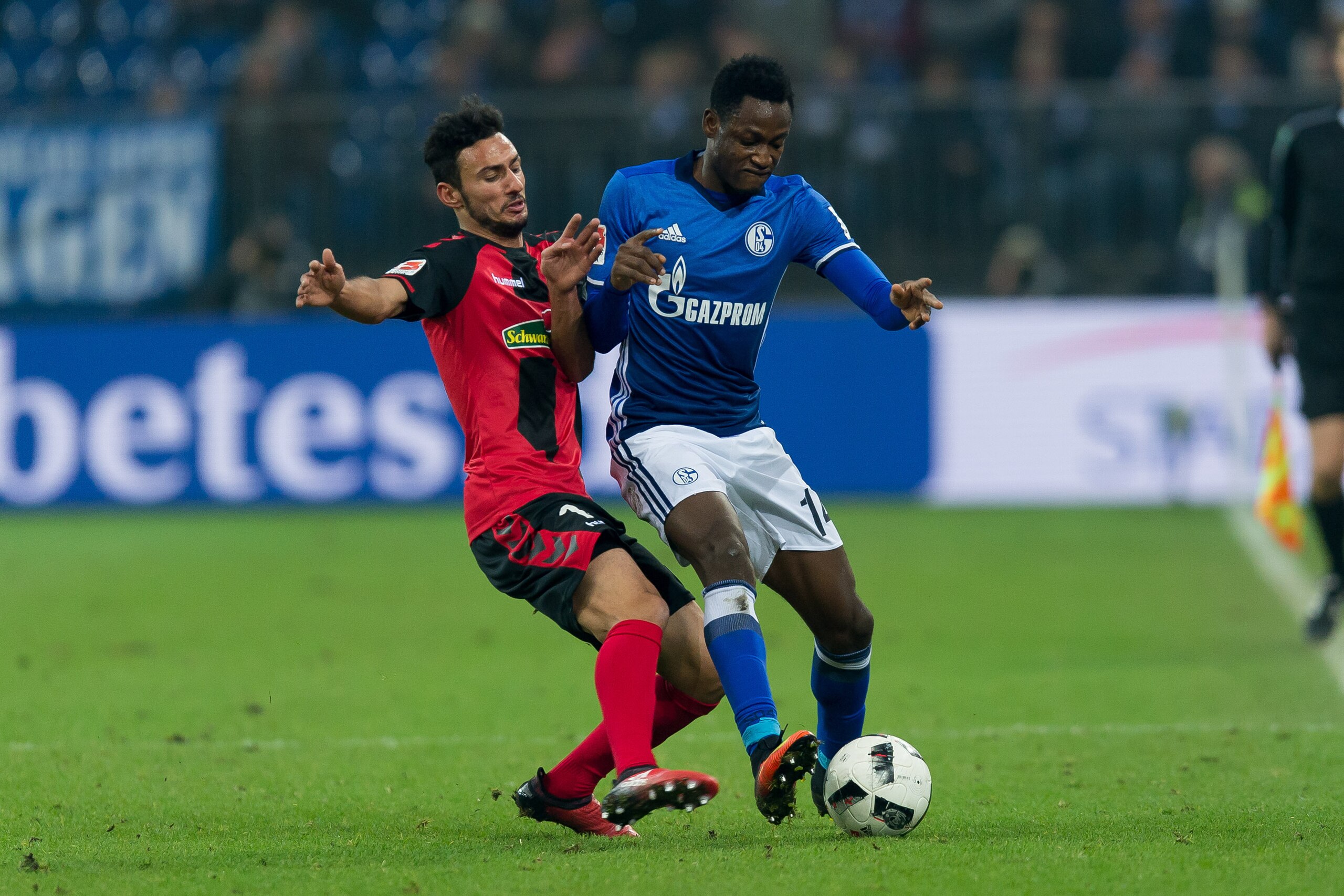 GELSENKIRCHEN, GERMANY - DECEMBER 17: Onur Bulut of Freiburg and Abdul Rahman Baba of Schalke battle for the ball during the Bundesliga match between FC Schalke 04 and SC Freiburg at Veltins-Arena on December 17, 2016 in Gelsenkirchen, Germany. (Photo by 