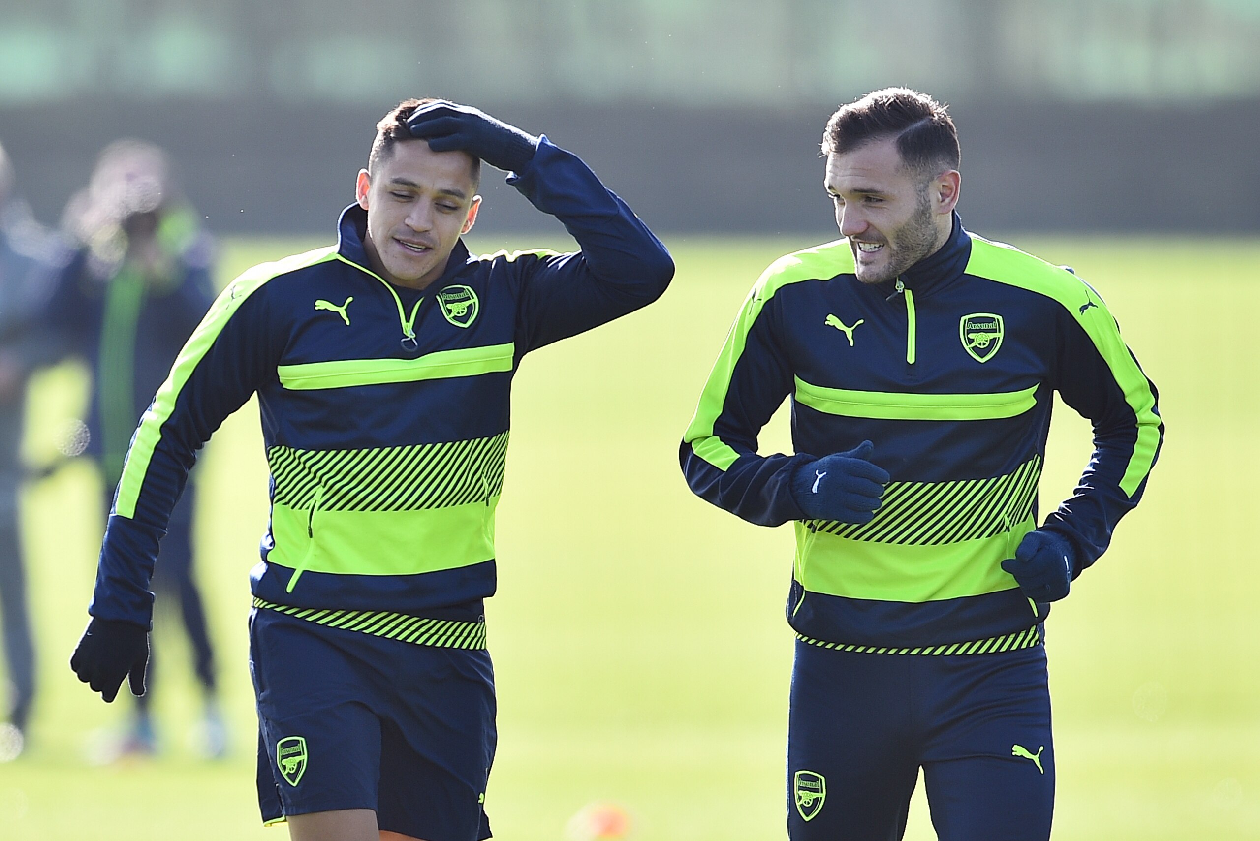 Arsenal's Chilean striker Alexis Sanchez (L) and Arsenal's Spanish striker Lucas Perez are seen during a training session ahead of their UEFA Champions League round of 16 second leg football match against Bayern Munich at Arsenal's London Colney training 