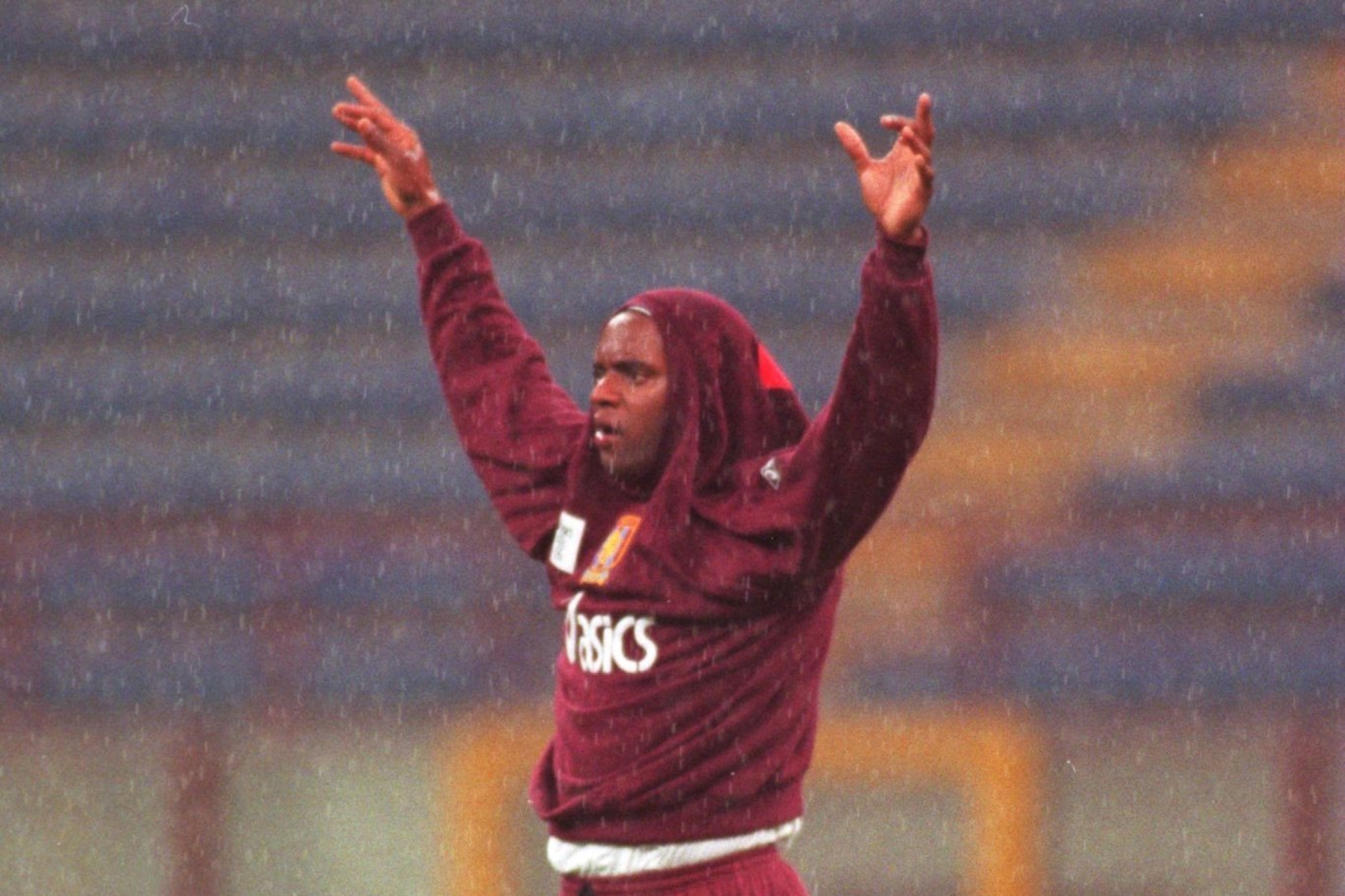 14 SEP 1994:  DALIAN ATKINSON OF ASTON VILLA TAKES SHELTER DURING A THUNDERSTORM AT THE SAN SIRO STADIUM IN MILAN BEORE TOMORROWS UEFA CUP FIRST LEG TIE WITH INTER MILAN.  Mandatory Credit: Mike Hewitt/ALLSPORT
