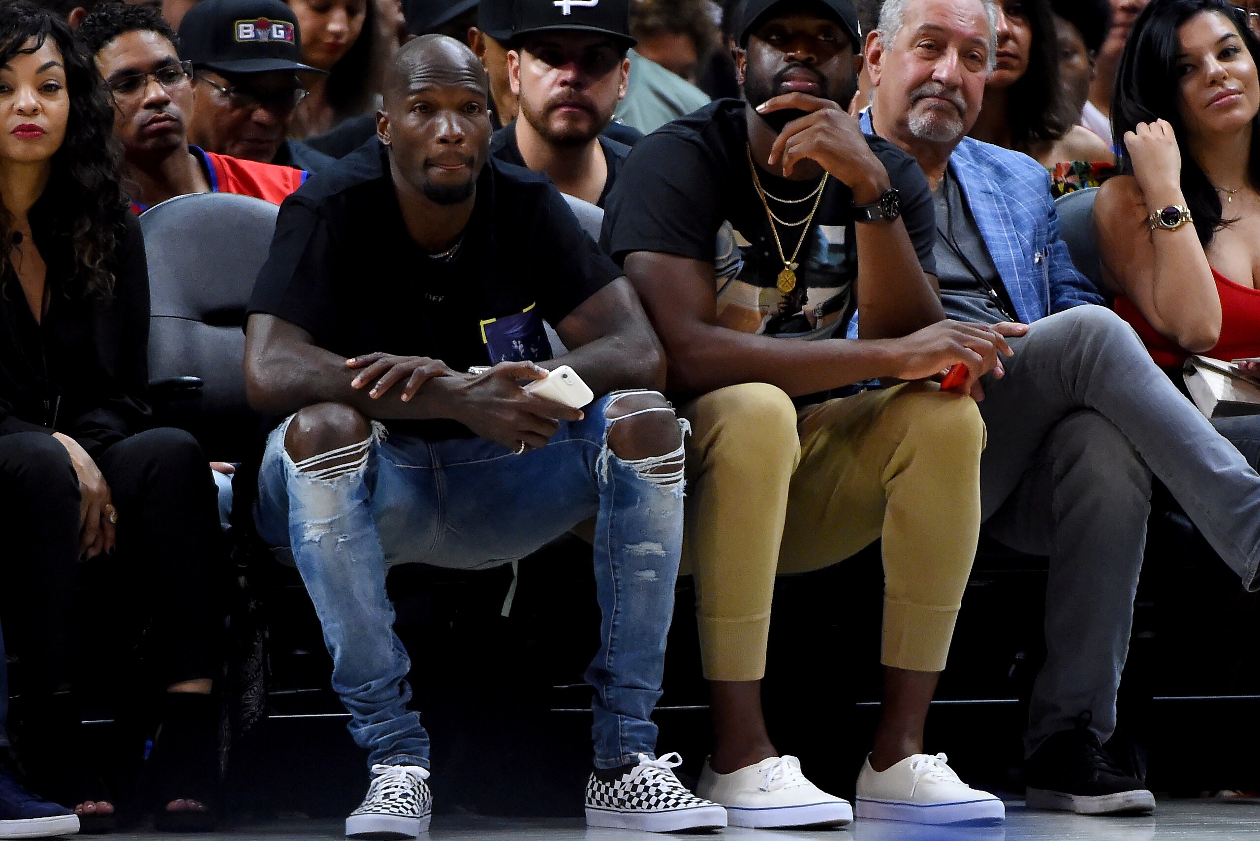 LOS ANGELES, CA - AUGUST 13:  Former NFL player Chad Johnson and Dwyane Wade of the Chicago Bulls watch the game between Tri-State and Power during week eight of the BIG3 three on three basketball league at Staples Center on August 13, 2017 in Los Angeles