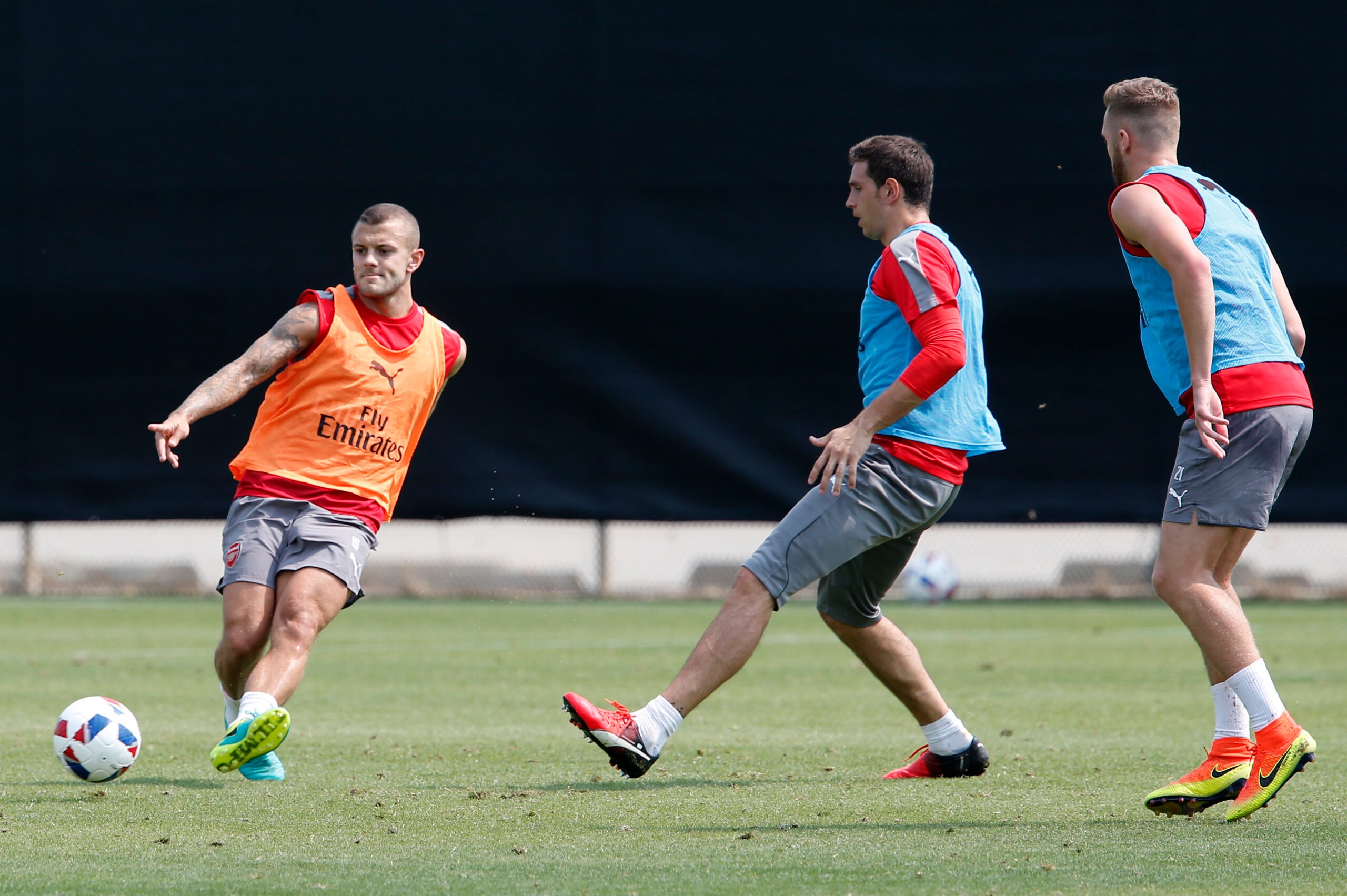 Jul 27, 2016; San Jose, CA, USA; Arsenal midfielder Jack Wilshere (left) kicks the ball during training for the MLS All Star Game at San Jose State University. Mandatory Credit: Jerry Lai-USA TODAY Sports